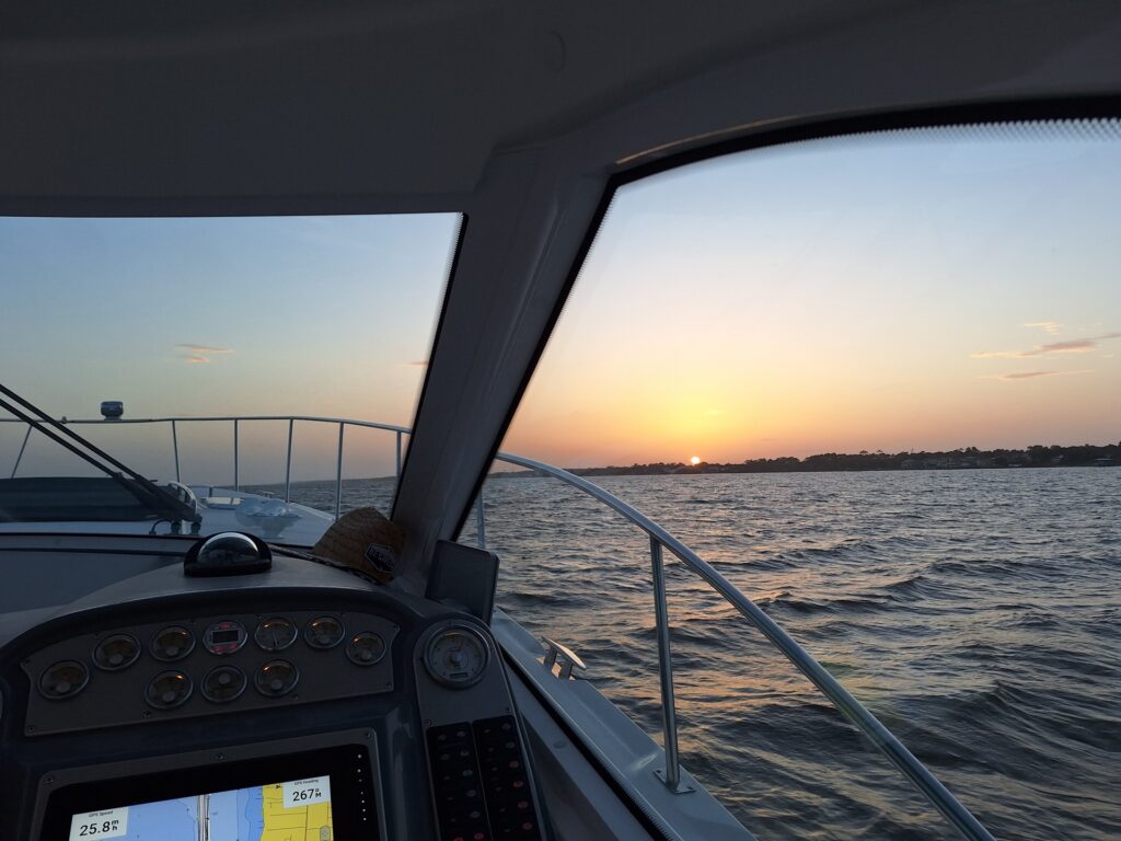 Captain's helm at sunset aboard the Infinity Getaway Charters yacht
