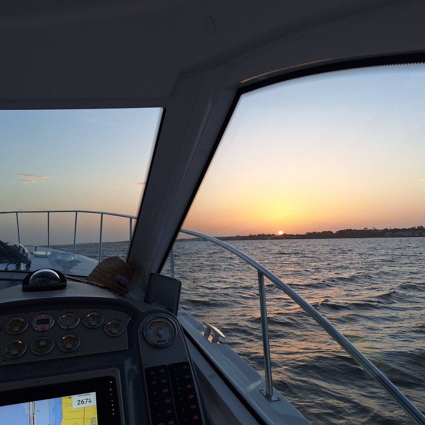 Captain's helm at sunset aboard the Infinity Getaway Charters yacht